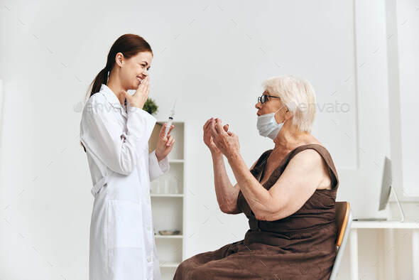 Nurse giving an injection to an elderly woman vaccination vaccine passport