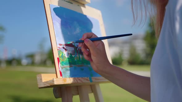 Female Artist Has Almost Finished Plein Air Painting alt