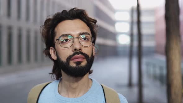 Confident Successful Young Adult Hipster Man Looking at Camera in City Street alt
