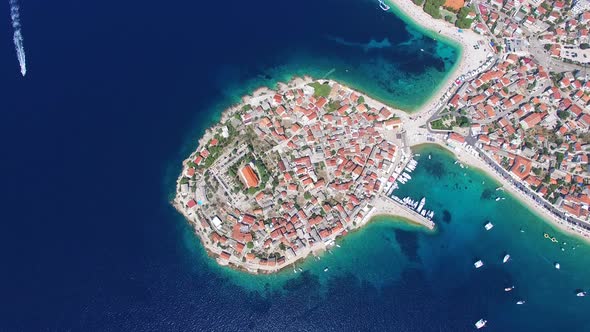 Aerial view of speedboat passing Primosten peninsula, Croatia alt