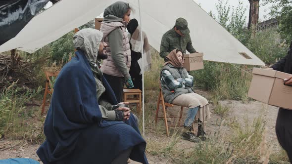 Refugees Accepting Donations at Immigrants Camp alt