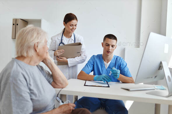 elderly woman patient doctor assistant in hospital