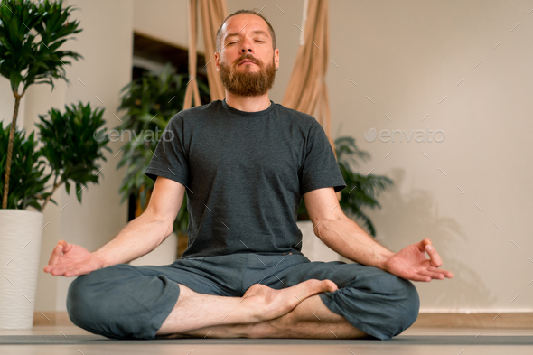 Young calm fit healthy African black woman at home doing yoga