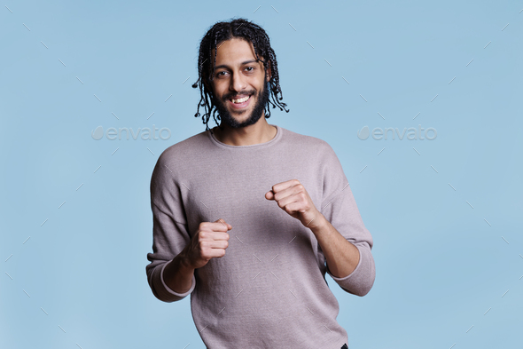 Middle eastern man does thumbs up Stock Photo by DC_Studio