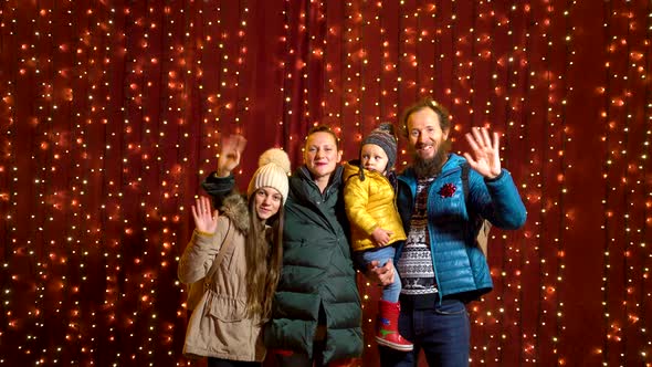Family posing for photo at Christmas market. alt