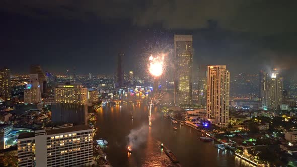 Fireworks with boats at Taksin Bridge with Chao Phraya River on New year day, Bangkok