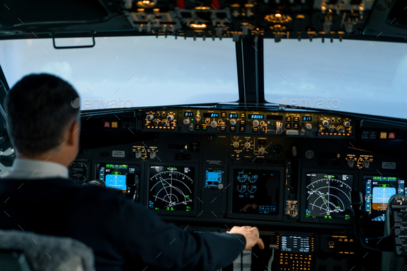 The pilot in the cockpit of aircraft turbulence during the flight simulator navigation devices