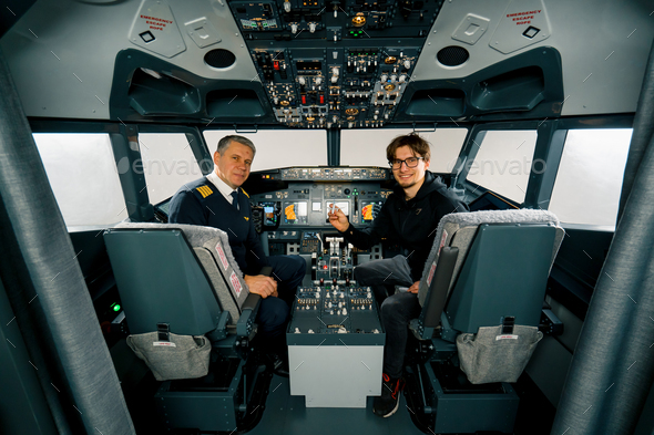airplane cockpit pilot and young student boy smiling after training on flight simulator