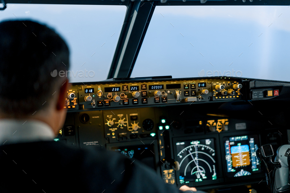 The pilot in the cockpit of the aircraft turbulence during the flight simulator navigation devices