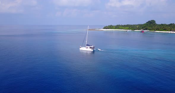 Beautiful above travel shot of a sandy white paradise beach and blue sea background in vibrant alt