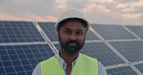 Portrait of Mixed Raced Male Engineer in Hard Helmet Looking To Camera. Bearded Man in Uniform alt