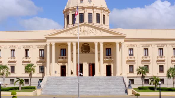 Ascent shot with drone of the Presidential Palace ofDominican Republic, overlooking the flagpole of alt