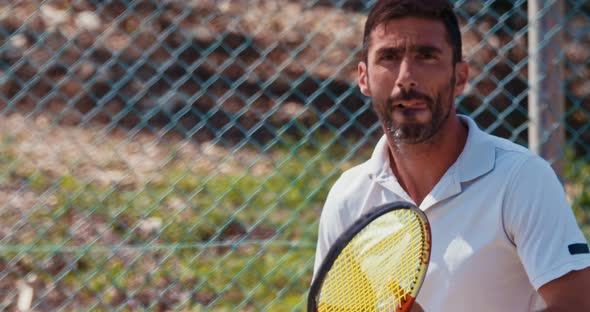 Slow motion of a tennis player hitting the ball during a tennis game alt