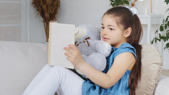 Caucasian Spaniard School Girl Child Kid Daughter Pupil Sitting on Couch Sofa at Home in Living Room alt
