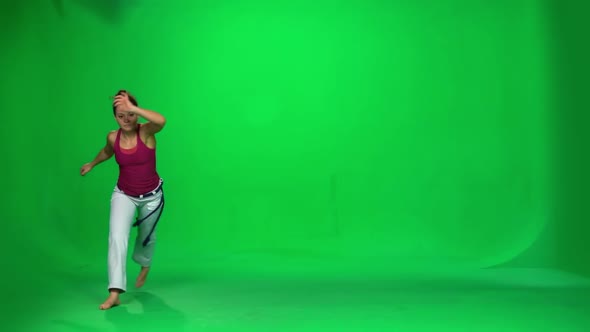 Brunette Female Practicing Capoeira on Green Screen. Slow Motion. alt