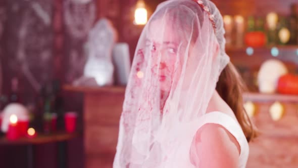 Teenage Girl Dressed in Halloween Costume of a Dead Bride Stained in Blood alt