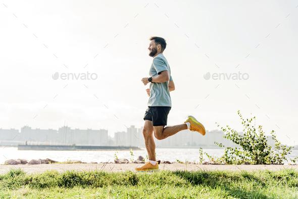 Jogging male runner. A healthy person trains alone in fitness clothes ...