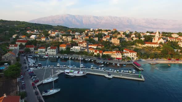 Aerial drone shot of the marina with mountainous background in Selca Island Brac Croatia Europe alt