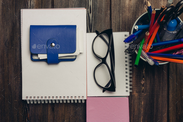 office desk with stationery and scissors pencils business card holder in  hands Stock Photo by shotprime