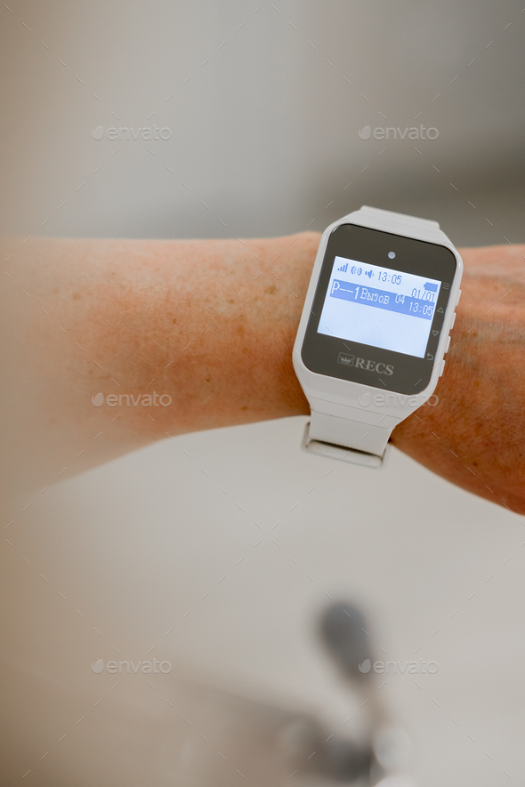 doctor or nurse watch with notification of emergency call from patient in medical clinic technology