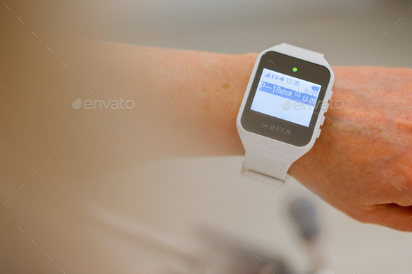 doctor or nurse watch with notification of emergency call from patient in medical clinic technology