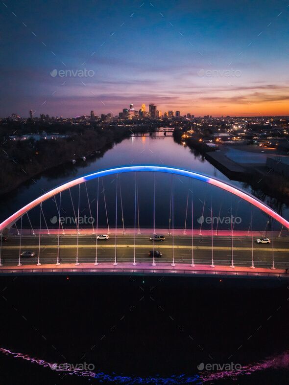 a bridge that has been lit up in blue and red Sunset by the Lowry