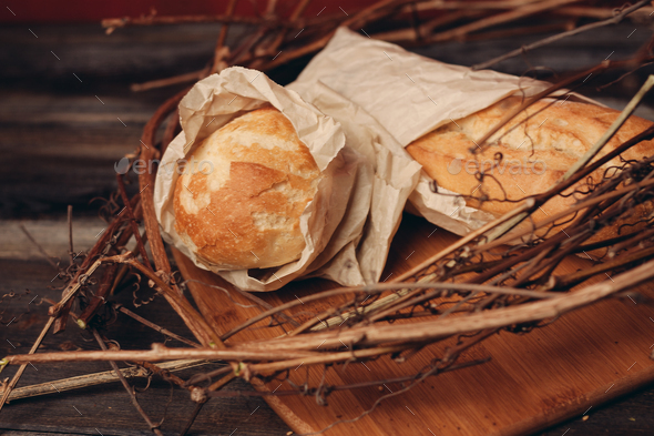 a loaf of fresh bread flour product in a bird's nest on a wooden