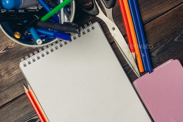 notepads colored pencils scissors office top view Stock Photo by