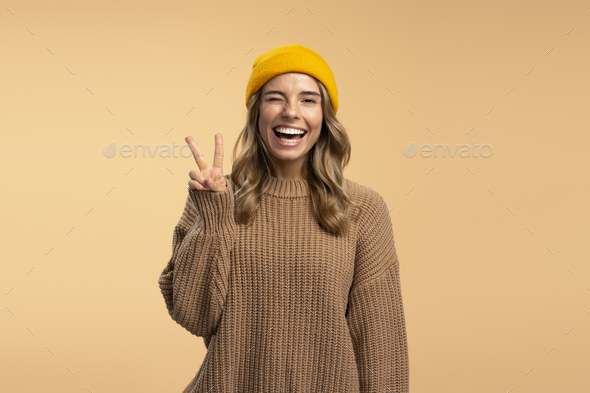 Happy beautiful girl smiling and looking up in stylish winter