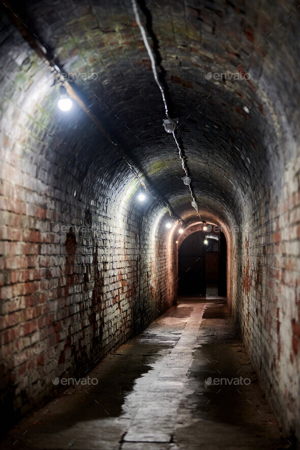 Loft brick tunnel in old German fort, secret passageway with old electricity wiring, Kaliningrad