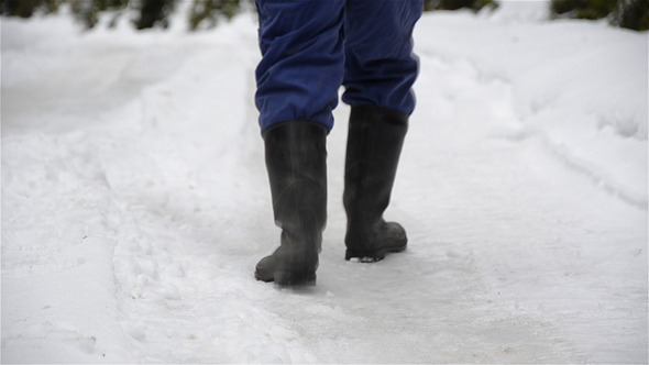 Man Walking On Snowy Road