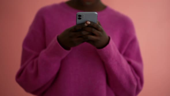 Smiling woman volunteer showing heart shape gesture at the camera alt