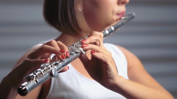 Professional Musician Female in Spotlight Playing on Flute. Studio Background