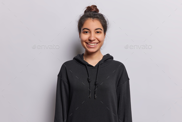 People positive emotions concept. Indoor waist up of young happy smiling Iranian girl looking