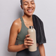 Vertical shot of Latin woman feels satisfied keep eyes closed dressed in activewear poses with towel - PhotoDune Item for Sale