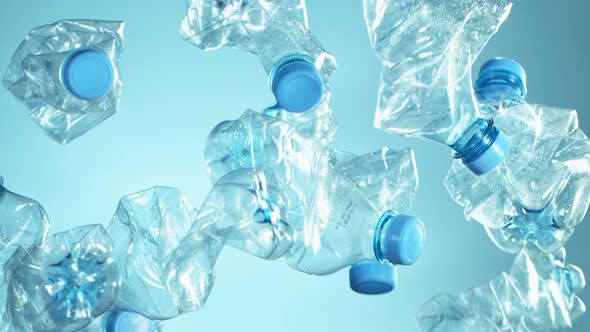 Super Slow Motion Shot of Flying Empty Plastic Bottles on Light Blue Gradient Background at 1000Fps. alt