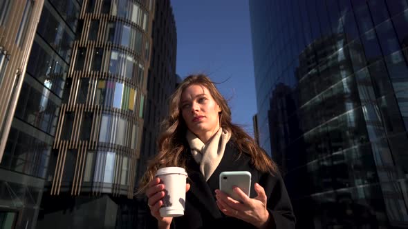 Young Business Woman On A Mobile Phone Infront of Business Center