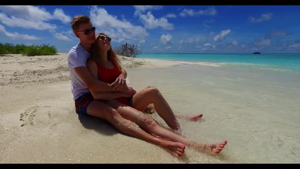 Guy and girl engaged on exotic lagoon beach adventure by blue ocean with bright sandy background of  alt