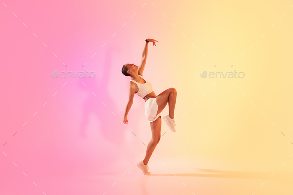 An exuberant young dancer in a dynamic pose captures the essence of movement and grace