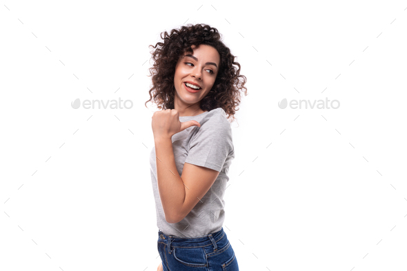 adorable slim curly brunette promoter woman with glasses dressed in gray basic t-shirt with logo