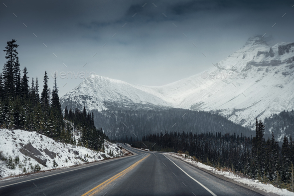 Scenic highway road trip with snow mountain in gloomy at Icefields Parkway