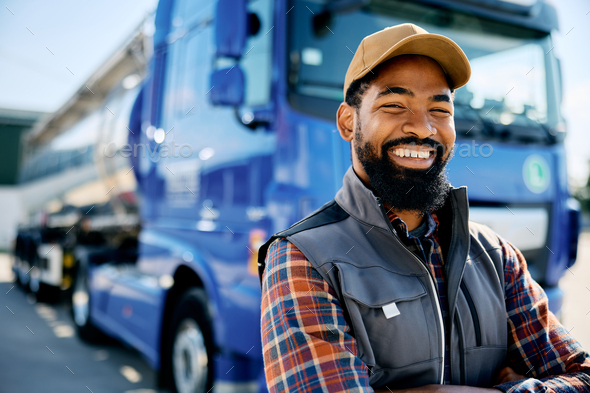 Portrait of happy black truck driver looking at camera.