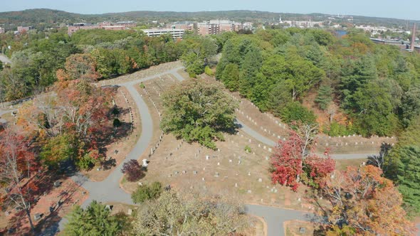 Aerial Drone Shot Flying Over Mt Feake Cemetery in Waltham Mass with Fall Colors alt