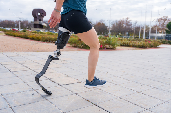 Disabled person with prosthetic leg running outdoors Stock Photo by Unai82