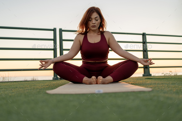 Plus size woman doing yoga and meditation.Plus size woman doing