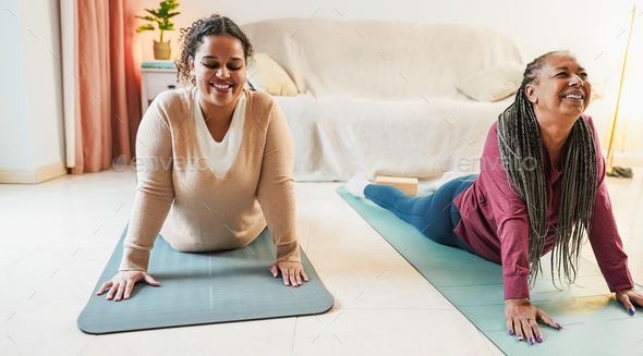 Mother and daughter doing yoga day routine at home together Stock Photo ...