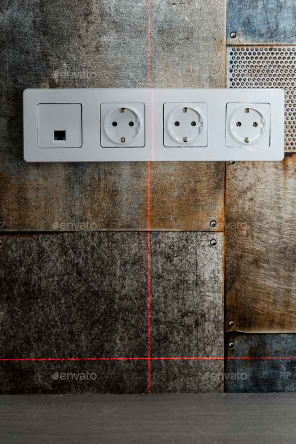 Measuring distance between electrical outlets using laser meter on wall