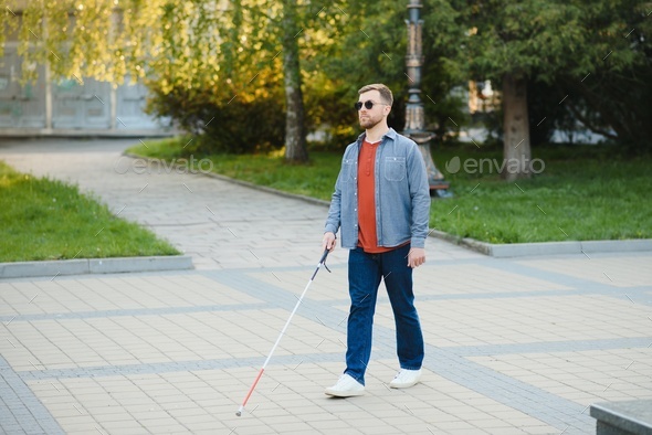 young blind man with white cane walking across the street in city Stock  Photo by sedrik2007