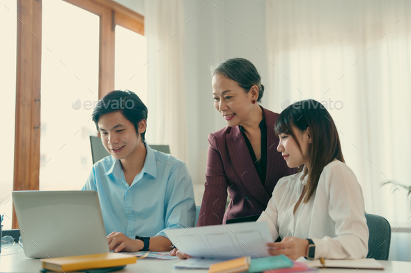 Asian boss or senior employee provide professional help and guidance to intern