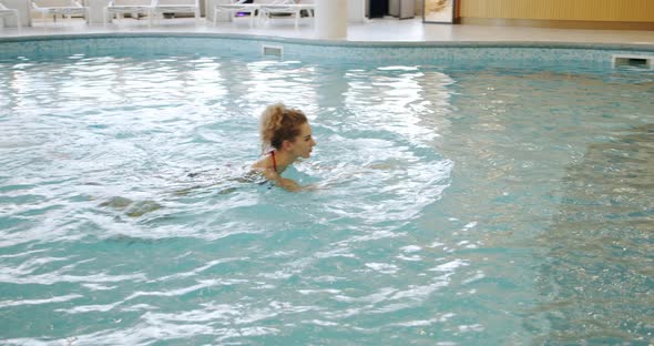 Girl Swims in the Pool at the Spa alt